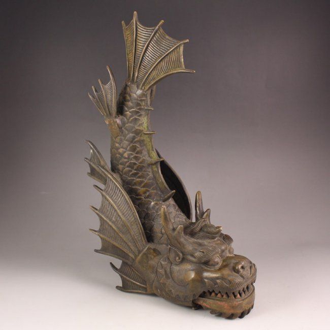 A statue of a koi-dragon with wings and horns