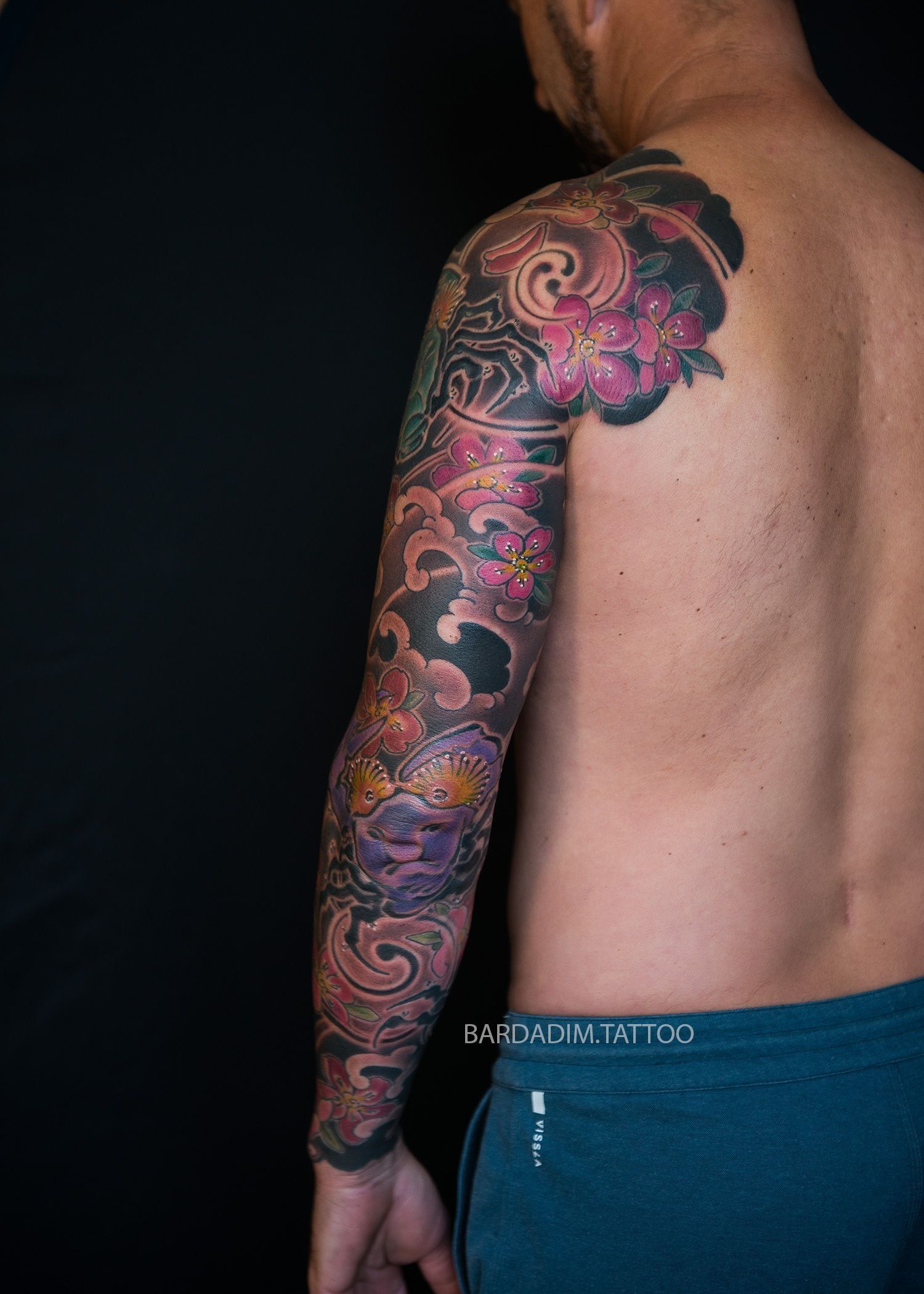 A man with a tattoo on his arm and shoulder.
