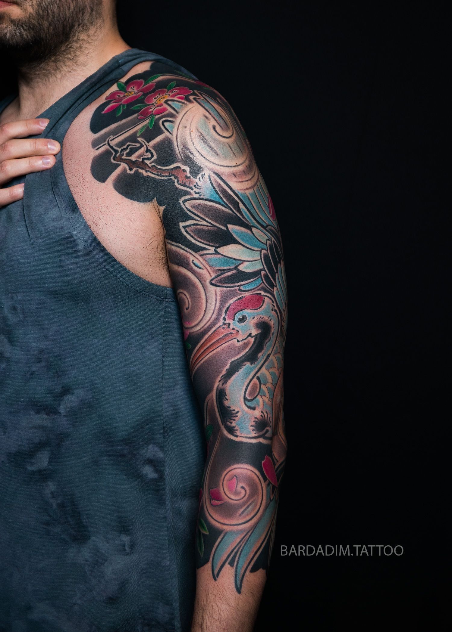 A man with a tattoo on his arm and shoulder.