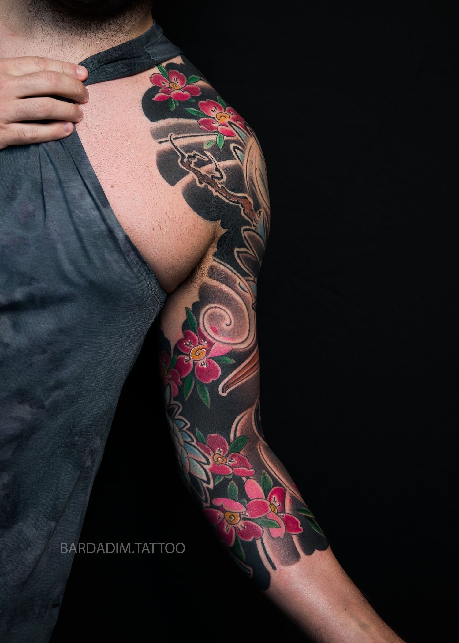 A man with a tattoo on his arm and shoulder.