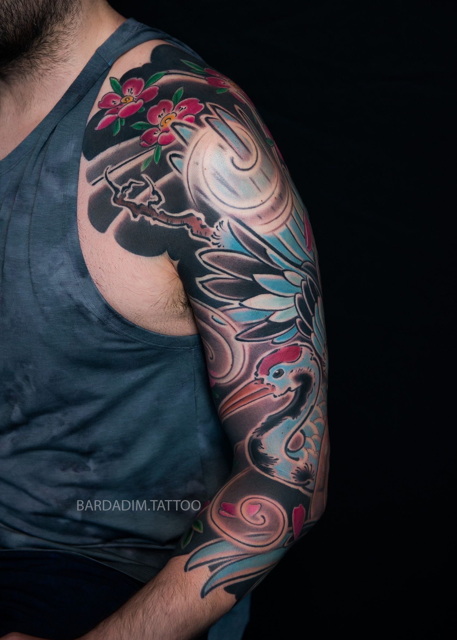 A man with a tattoo on his arm and shoulder.