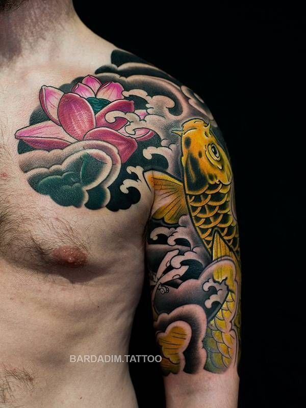 Tattoo of a golden koi fish and pink lotus flower surrounded by clouds on a person's shoulder and arm.