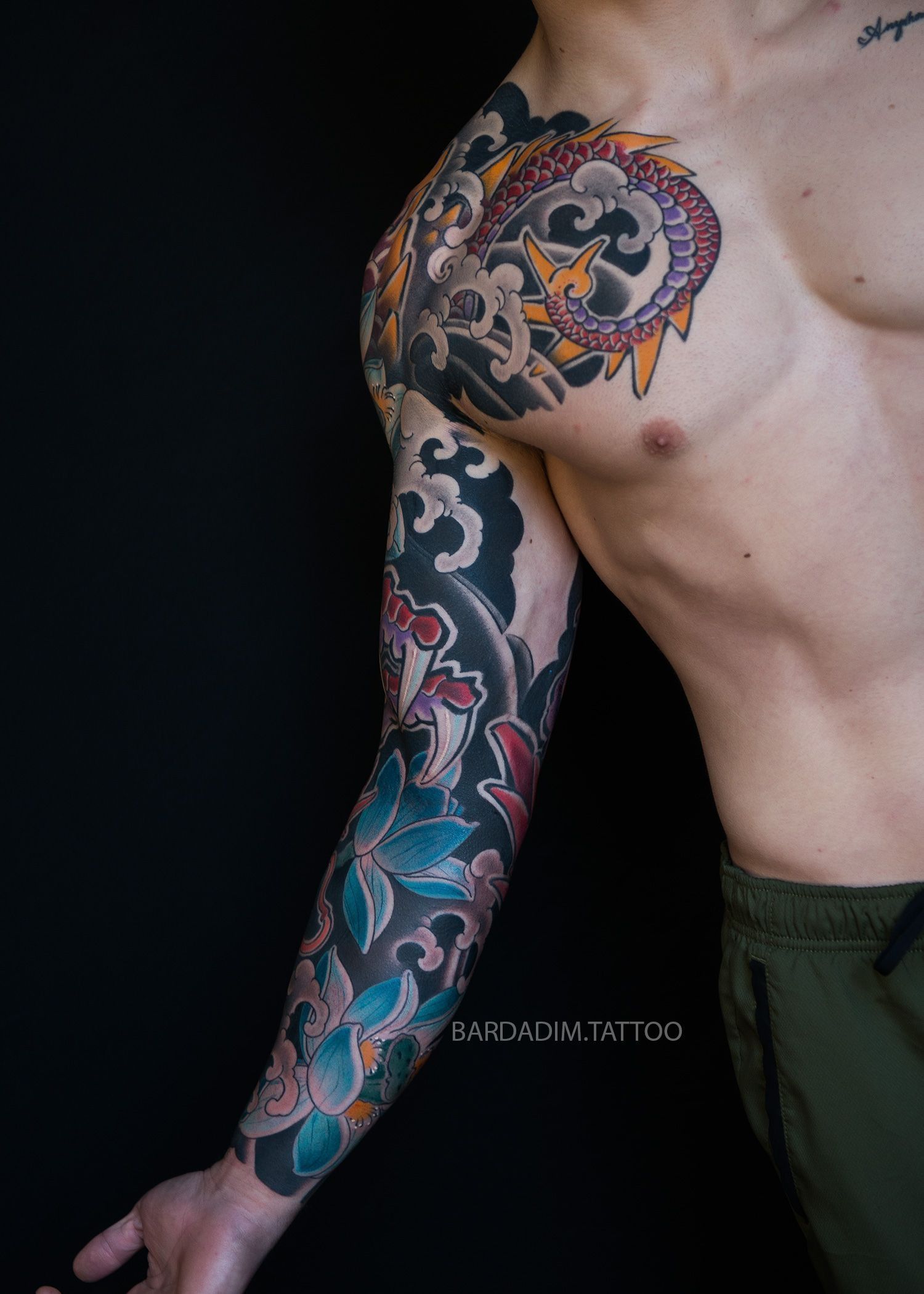 A man with a tattoo on his arm and chest.