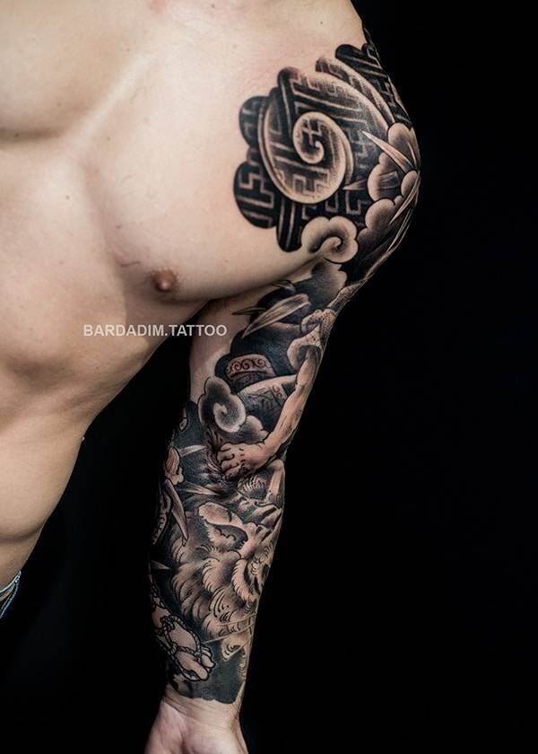 A man with a tattoo on his arm and chest.