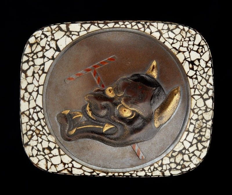 A plaque with a devil 's head on it