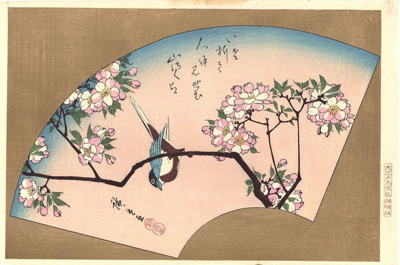 A fan with flowers and a bird on it