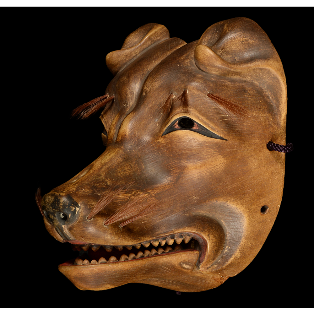 Wooden Kitsune mask with open mouth, showing teeth. Brown with dark eyes and string.