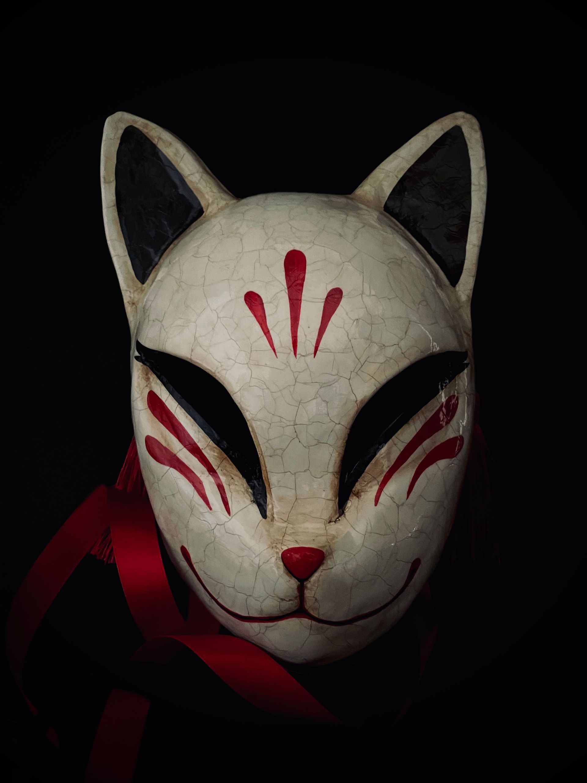 Traditional kitsune mask representing transformation and duality in Japanese symbolism
