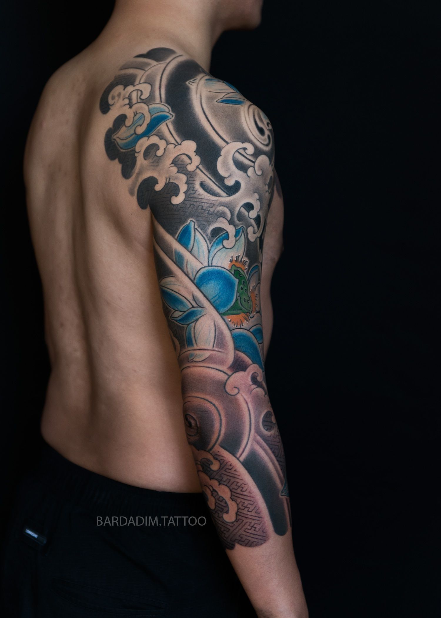 A man with a tattoo on his arm and shoulder