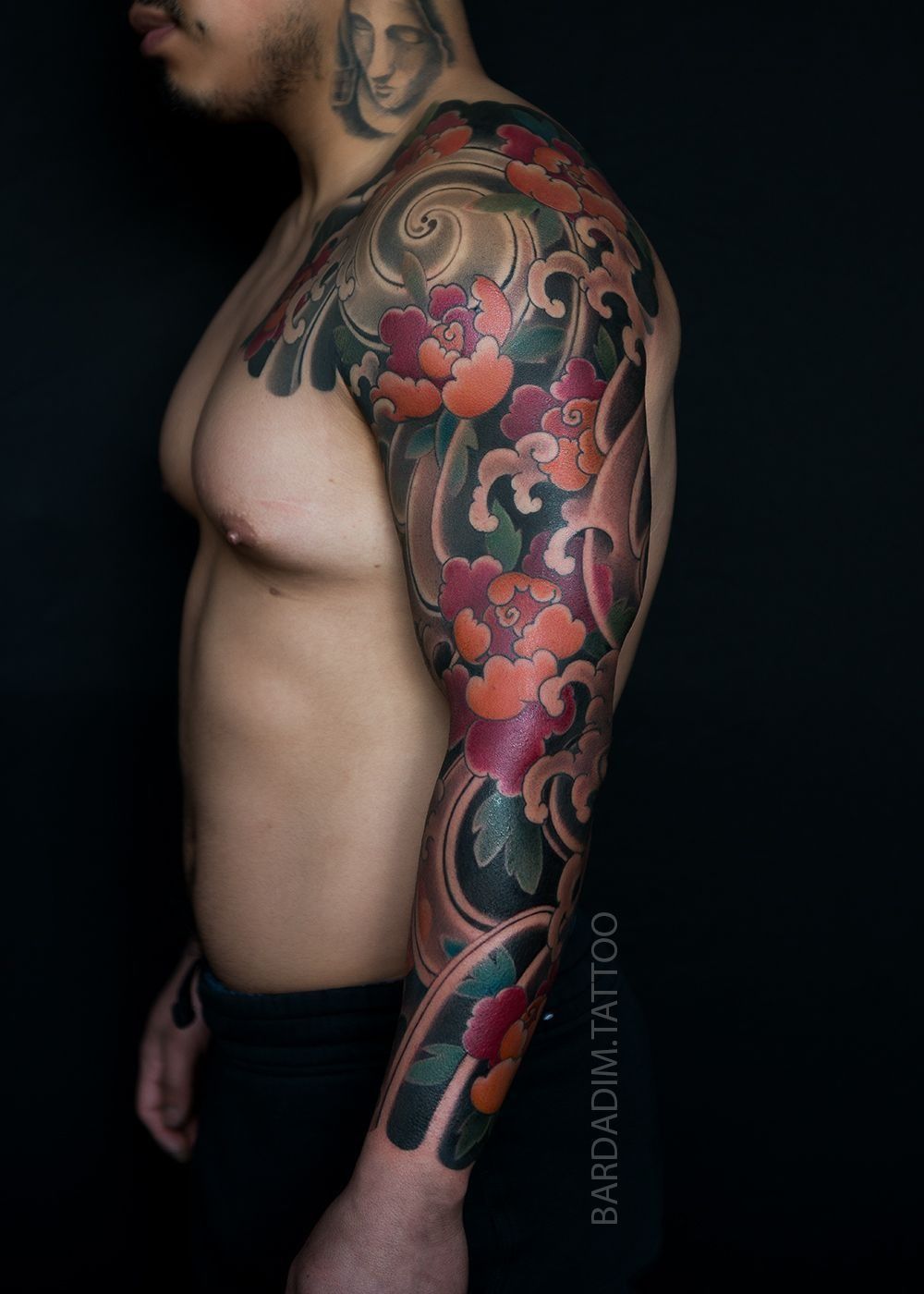 A man with a full sleeve tattoo on his arm.