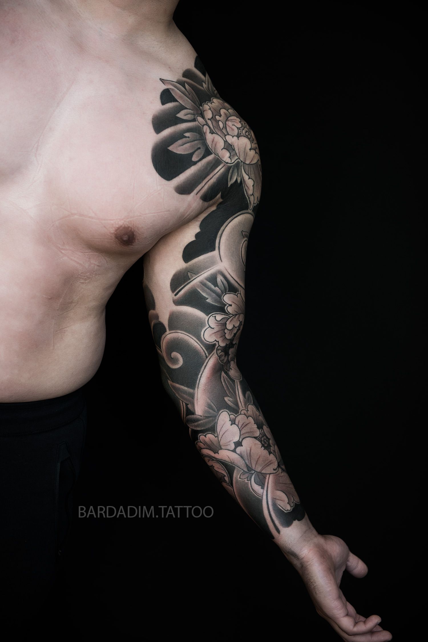 An angled view of the white peony Irezumi sleeve emphasizing depth, clean detailing, and dynamic int