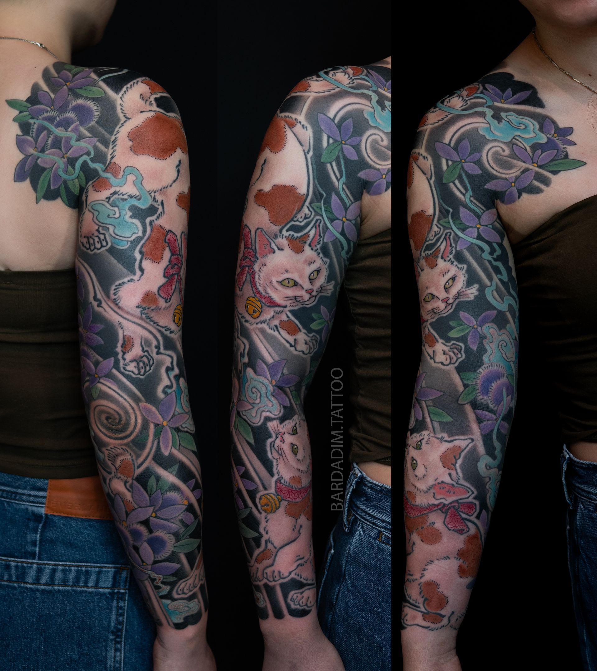 Woman's arm tattoo, sleeve design. Purple flowers, grey smoke, red spots. Against a black background.