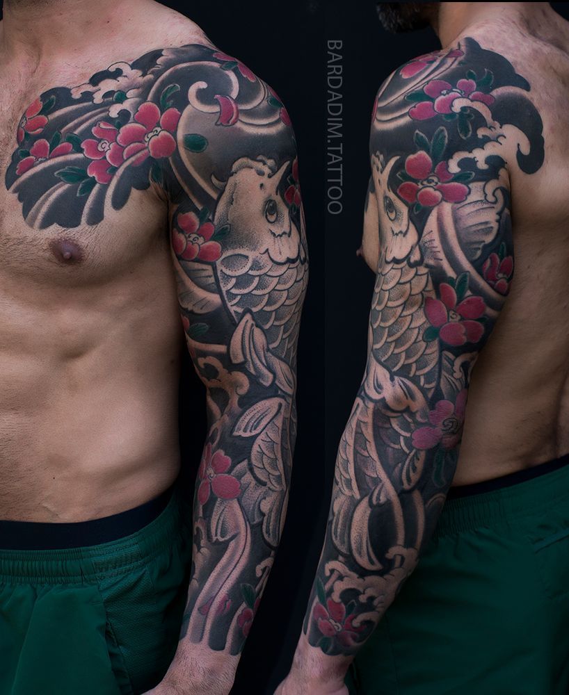 Tattoo of a koi fish and floral elements covering a man's arm and chest. Predominantly black, gray, and red.