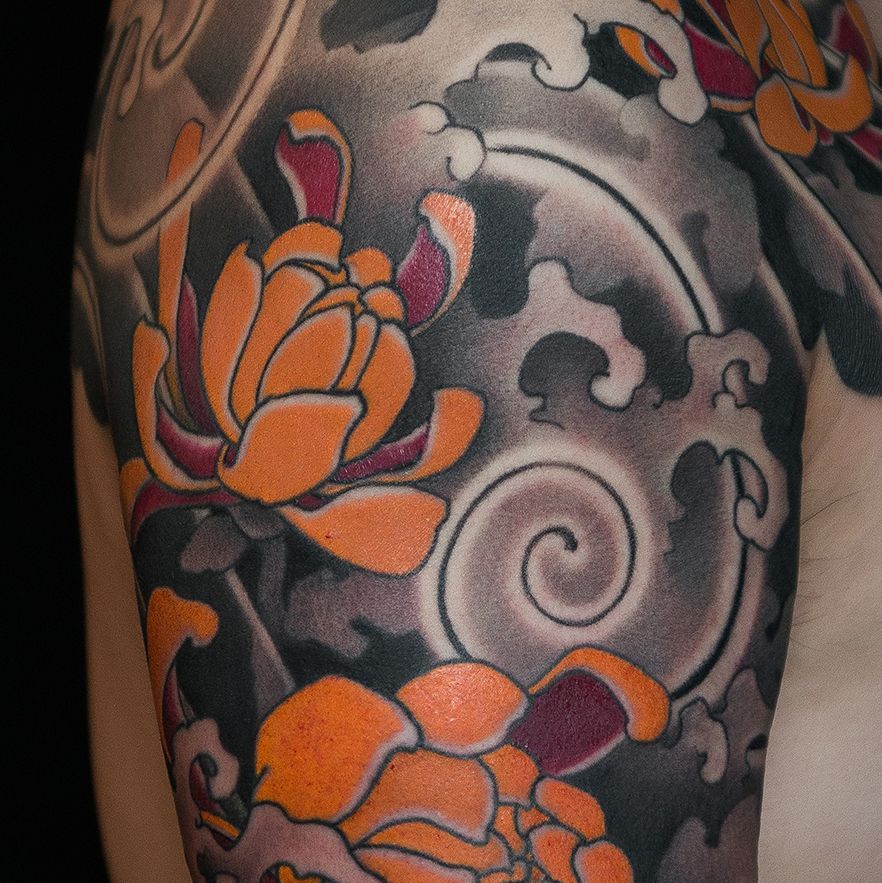 Japanese chrysanthemum flower tattoo with traditional irezumi background
