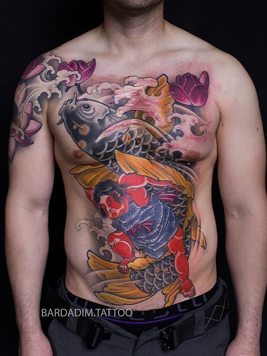 Man's chest tattoo: koi fish, samurai, waves, pink lotus flowers, vibrant colors.