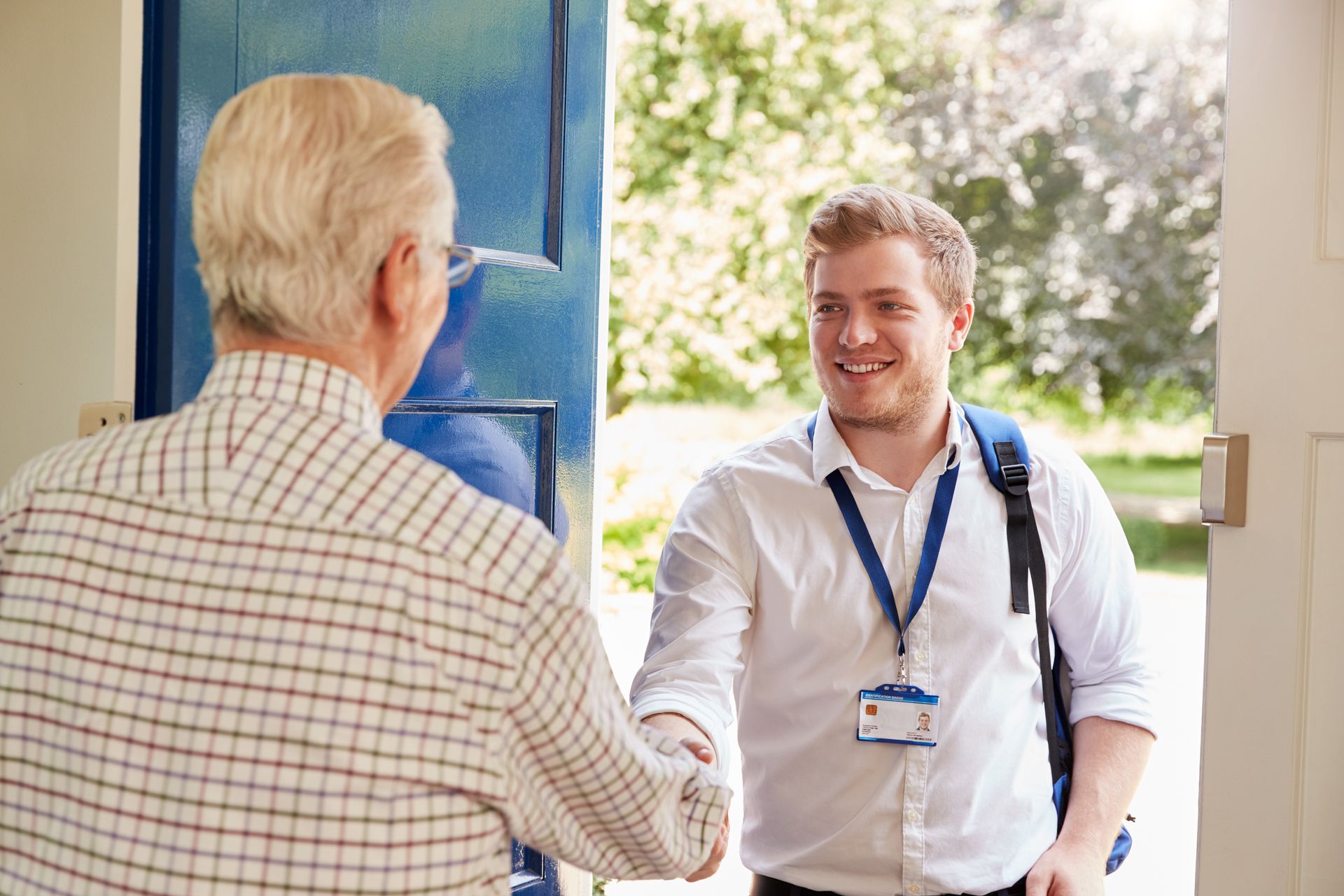 a nurse is talking to an elderly man and smiling .