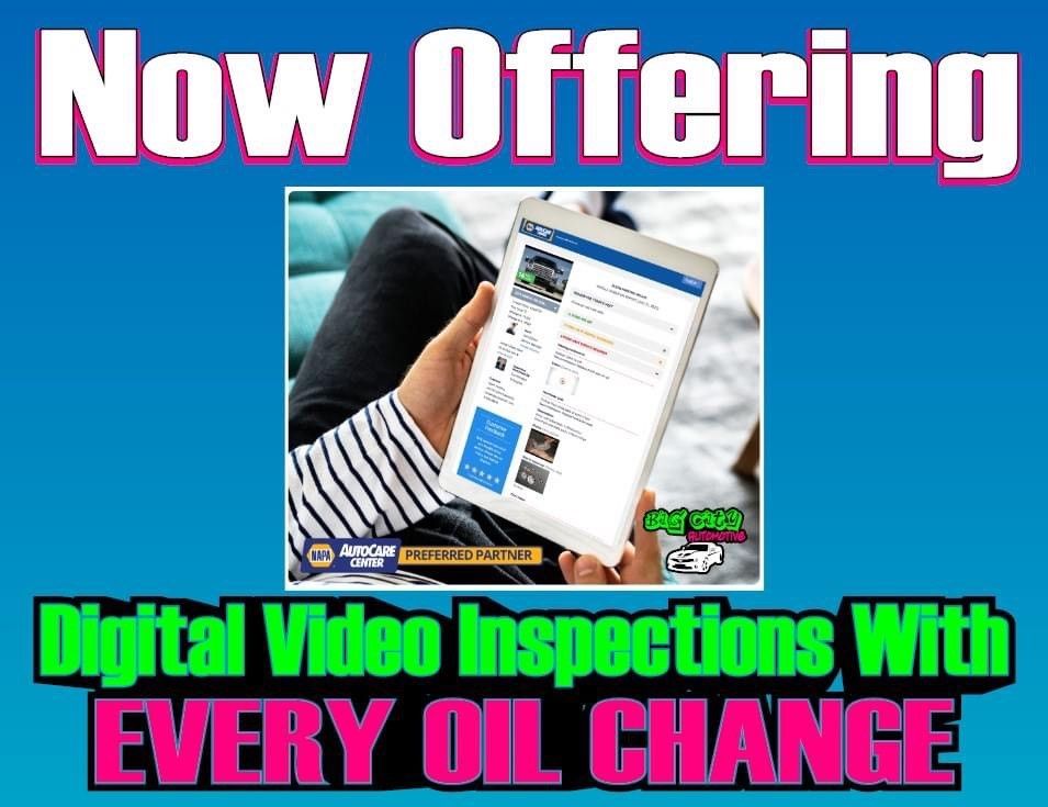 Advertisement: Digital video inspections with every oil change. Tablet screen, person's lap, blue background.