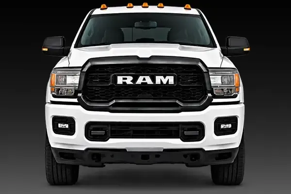 Front view of a white RAM pickup truck on a dark background