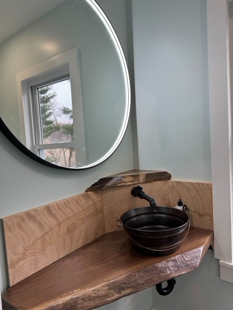 A bathroom with a sink and a mirror on the wall.