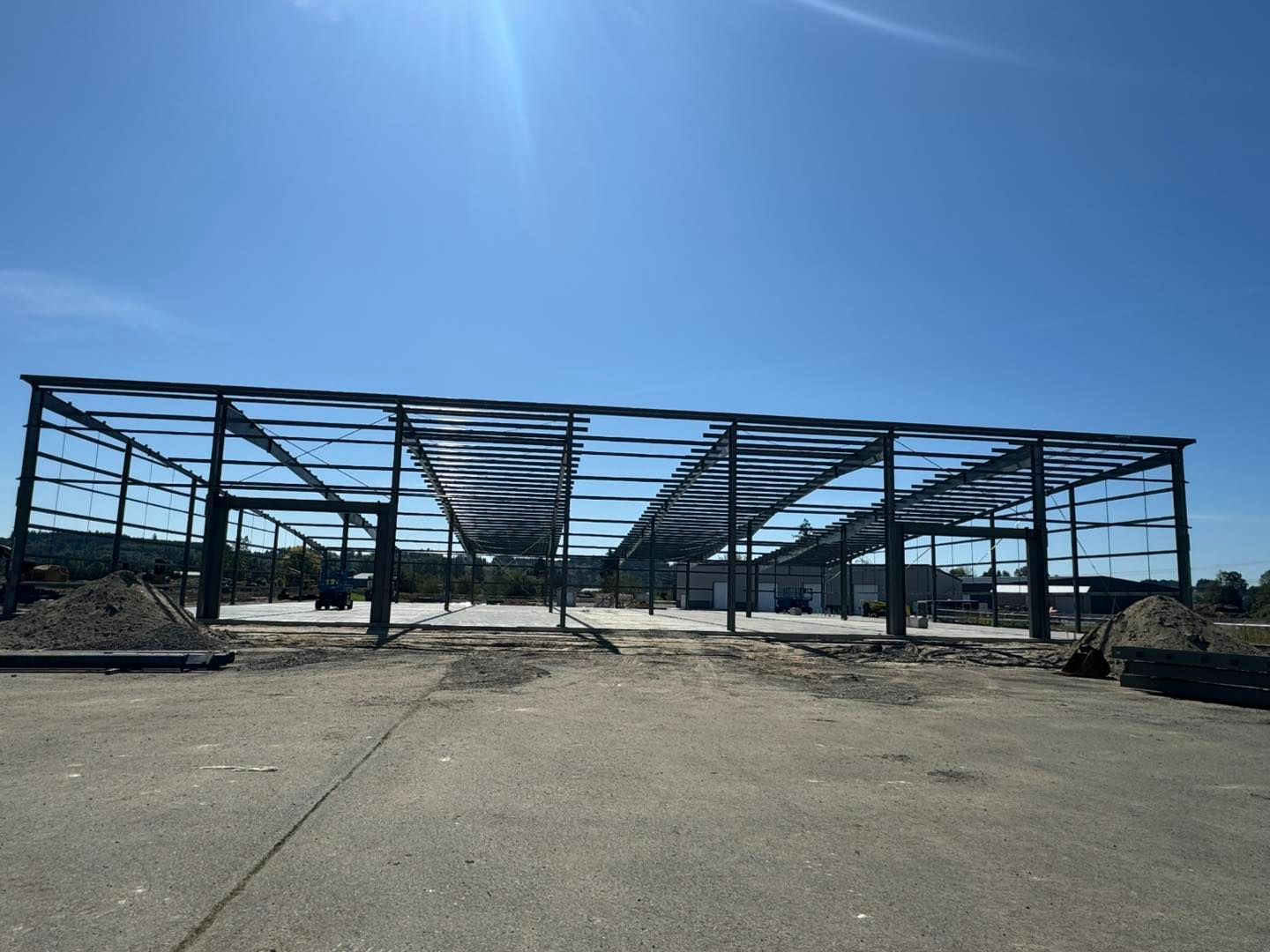 Abandoned steel building frame under a clear blue sky