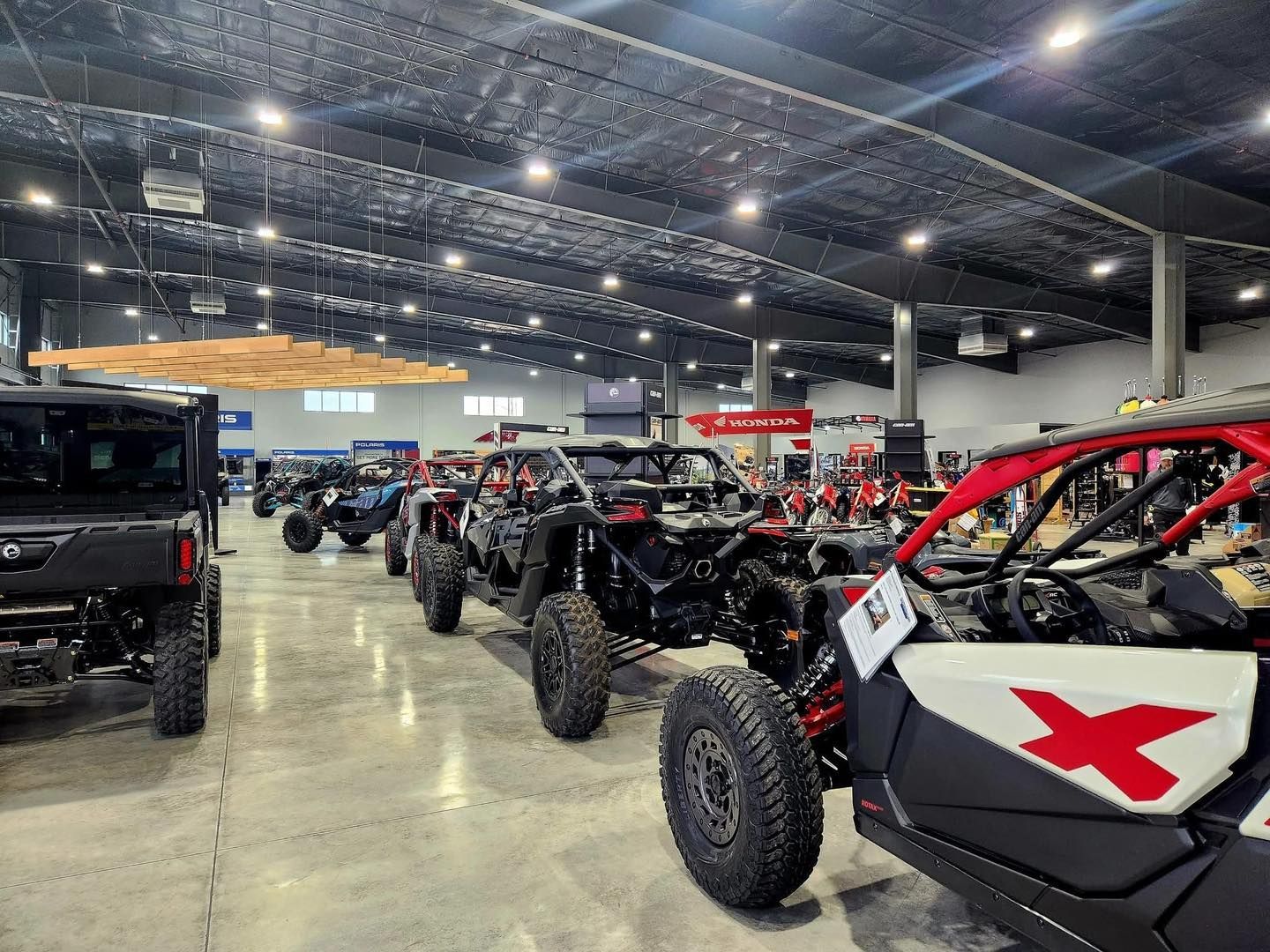 Indoor off-road vehicle display with several Jeeps and dune buggies in a large convention hall