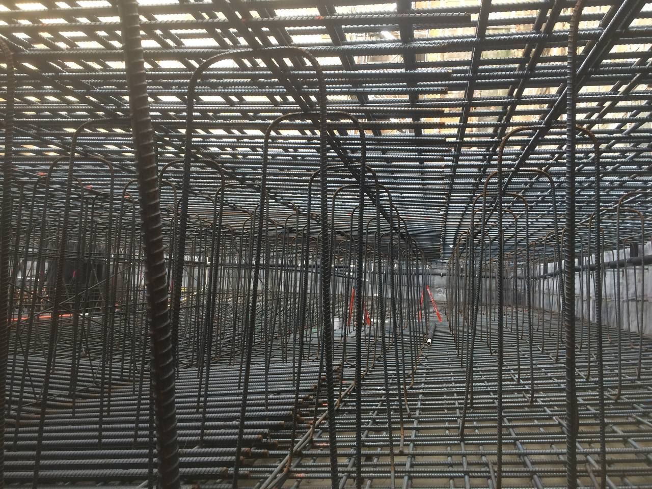Dense steel framework of a construction site with many vertical and horizontal beams