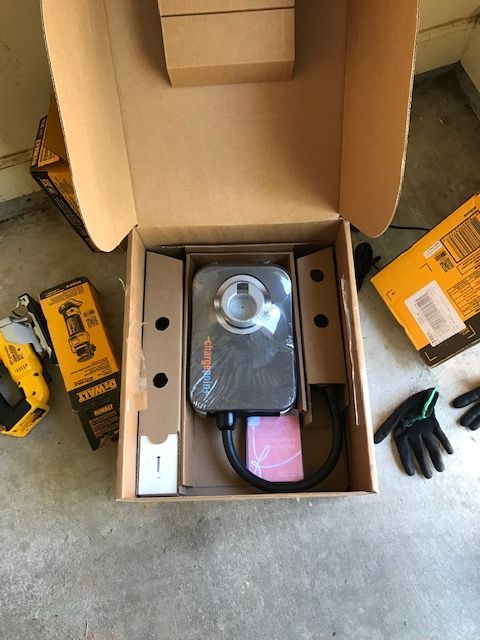 A cardboard box with a black device inside of it