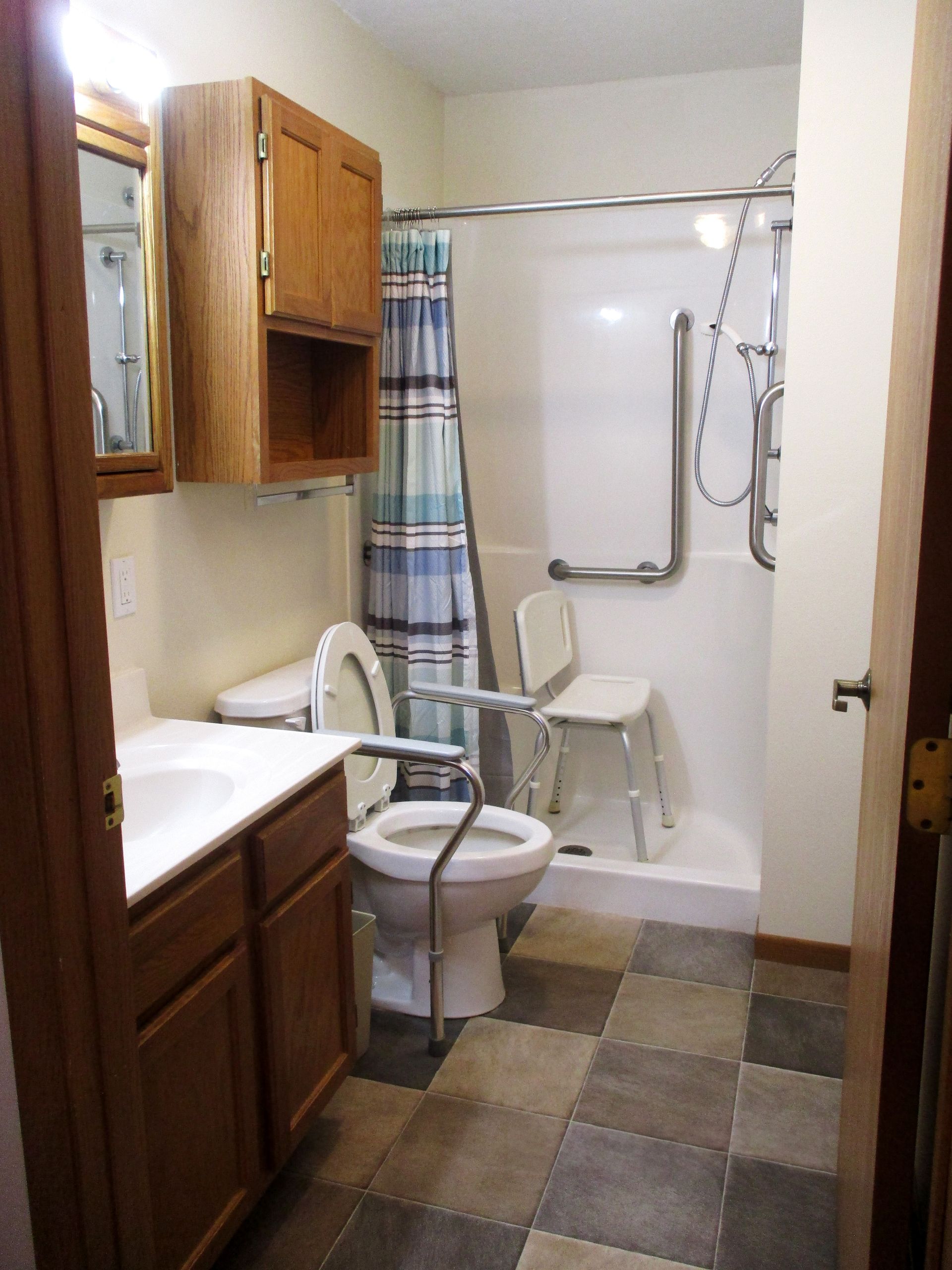A bathroom with a toilet a sink and a shower