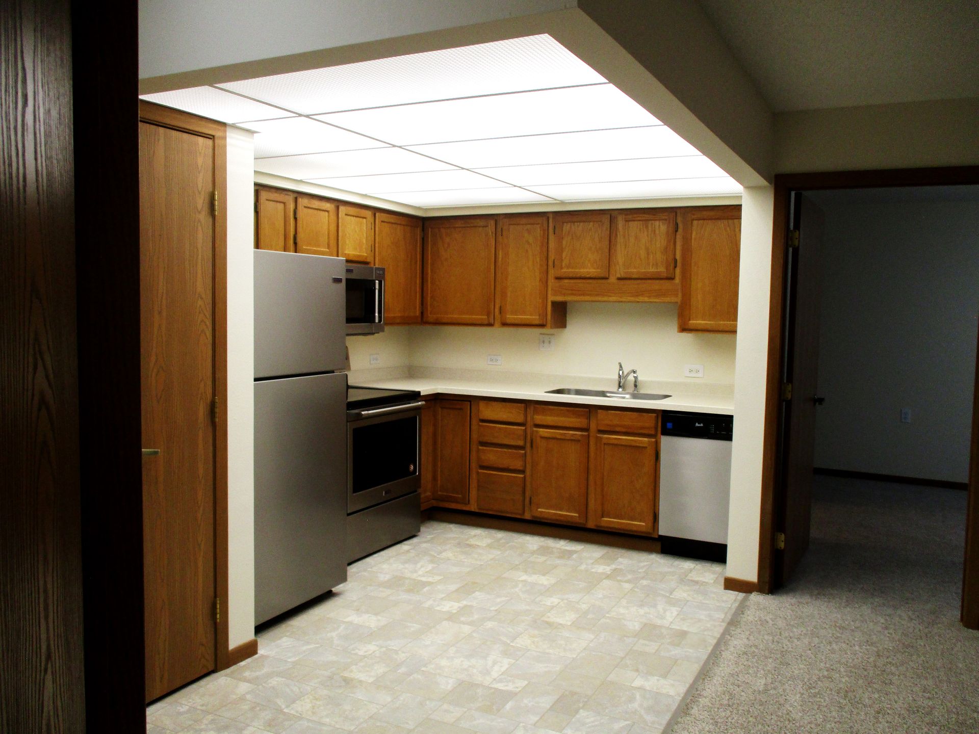 A kitchen with wooden cabinets and stainless steel appliances