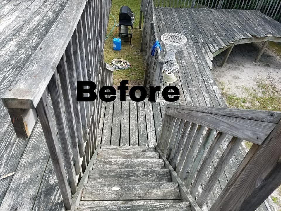 A before picture of a wooden deck with stairs leading up to it.