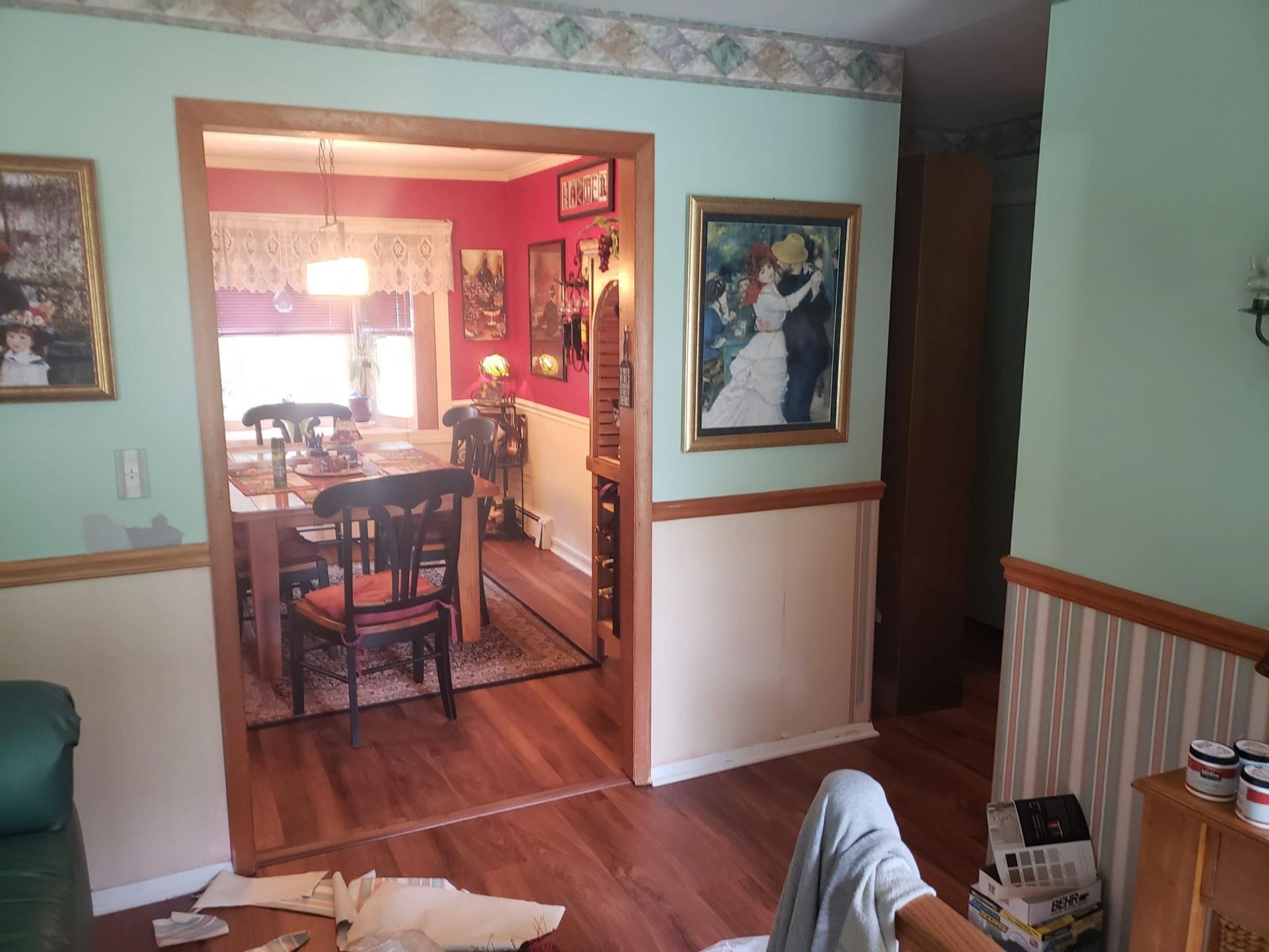 A living room with a painting of a bride and groom on the wall.
