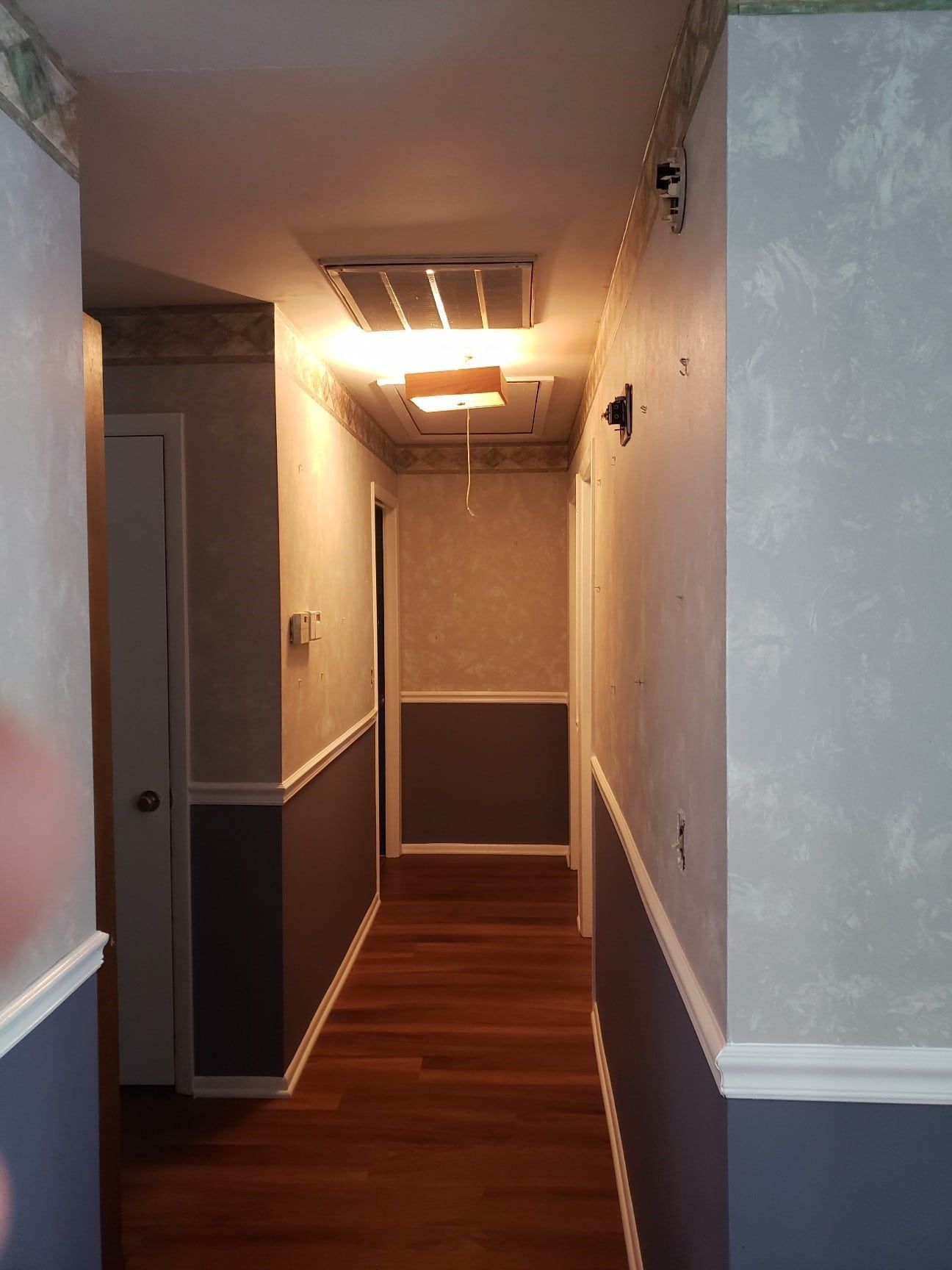 A long hallway with a light on the ceiling