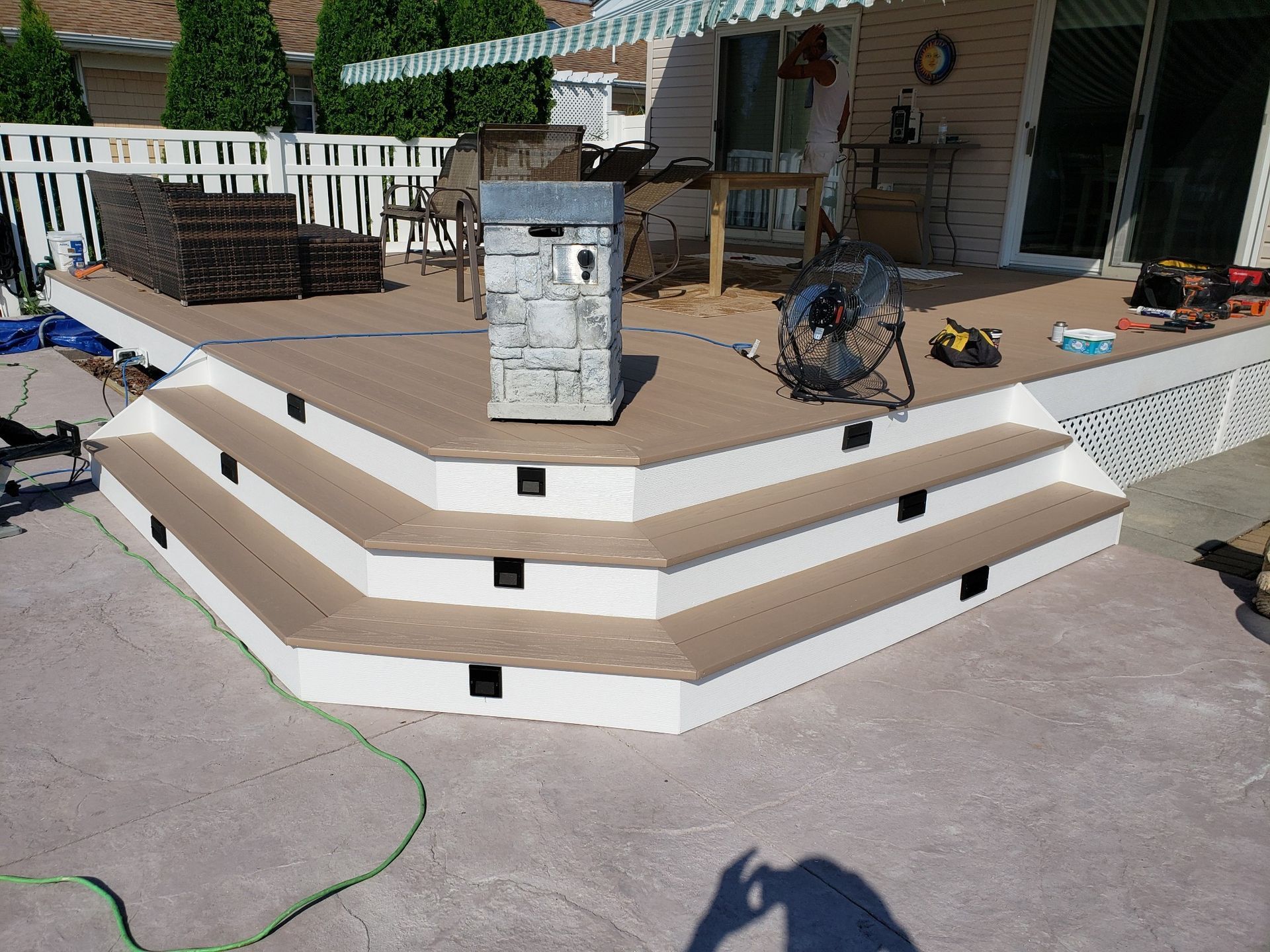 A deck with stairs and a fan on it