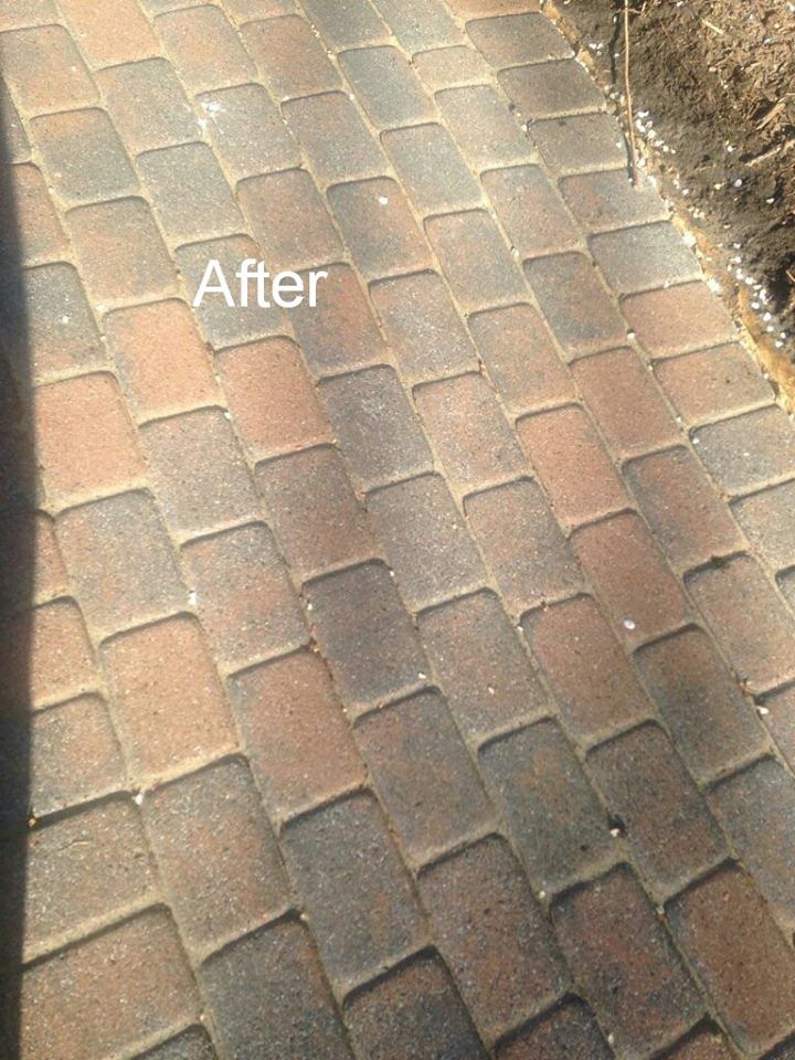 A picture of a brick walkway after being cleaned.