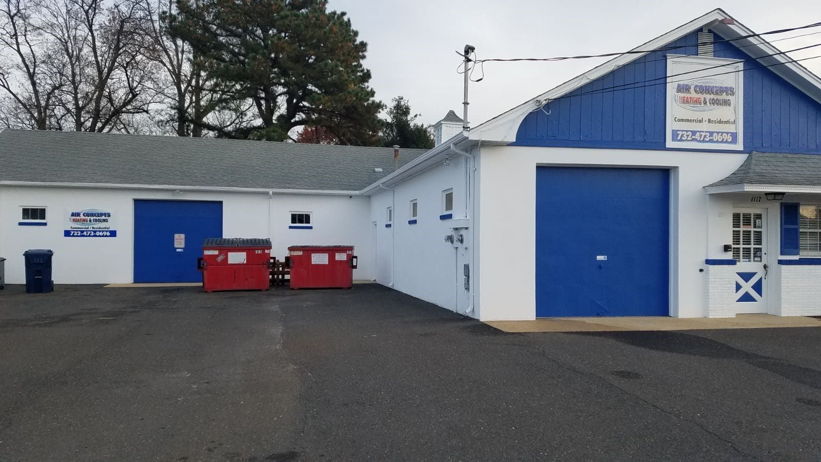 A blue and white building with a sign that says ' tommy ' on it