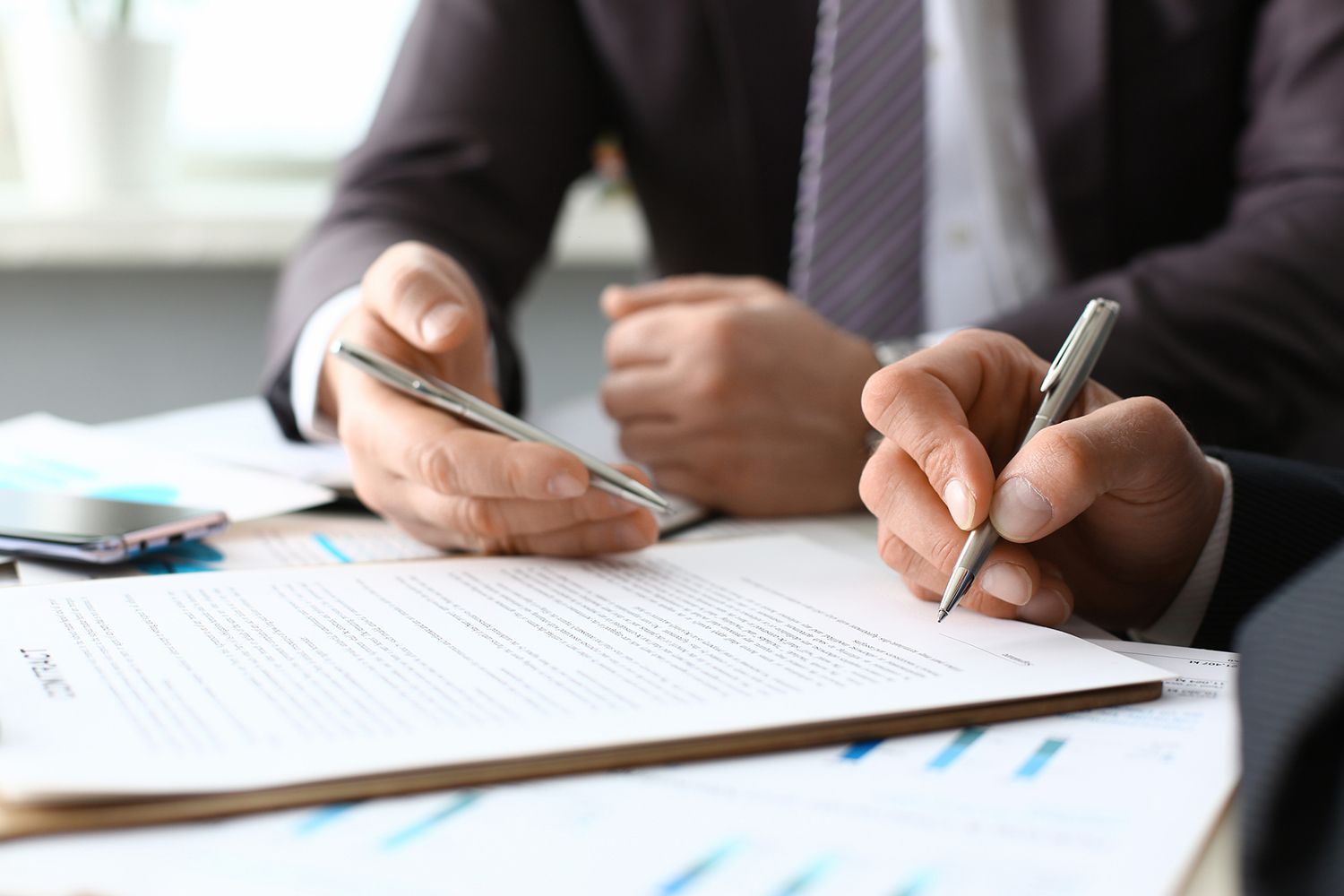 An employment law attorney discussing legal documents with a client.