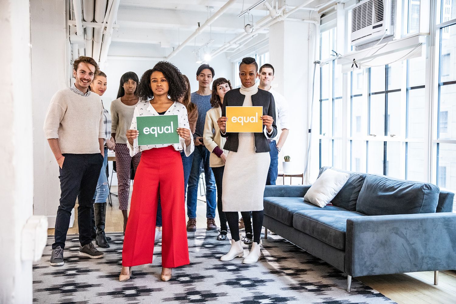 Diverse group of employees standing together for workplace equality.