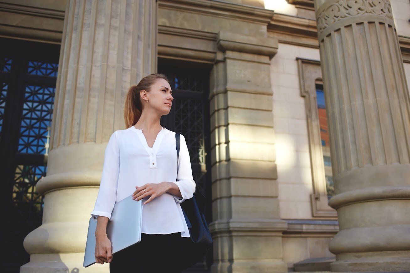 Woman Holding White Folder — Birmingham, AL — Allen D. Arnold Attorney at Law
