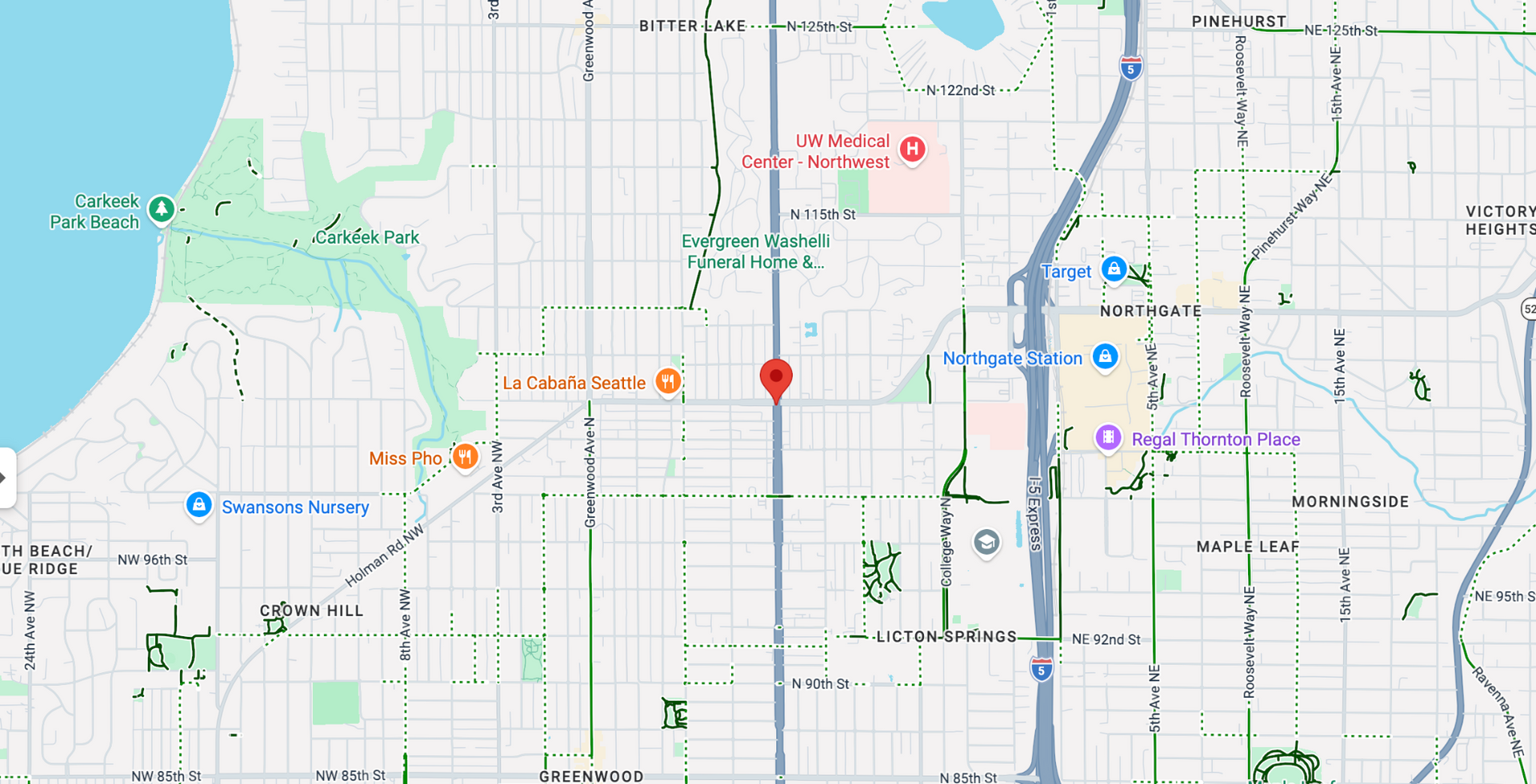 Map view of a city area with roads, river, parks, and several colored location markers