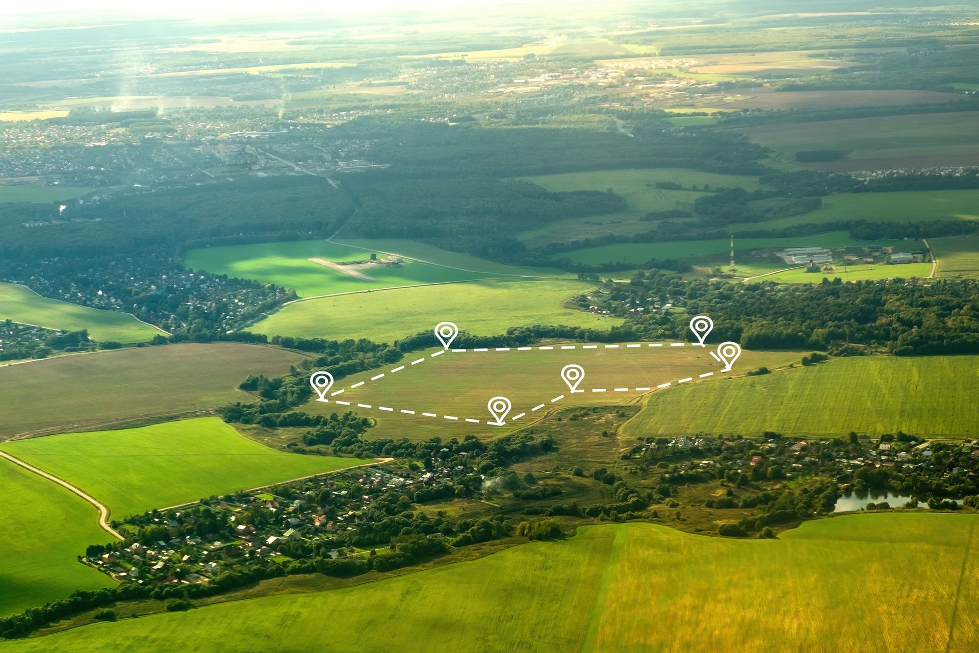 An aerial view of a lush green field with a circle drawn in the middle.