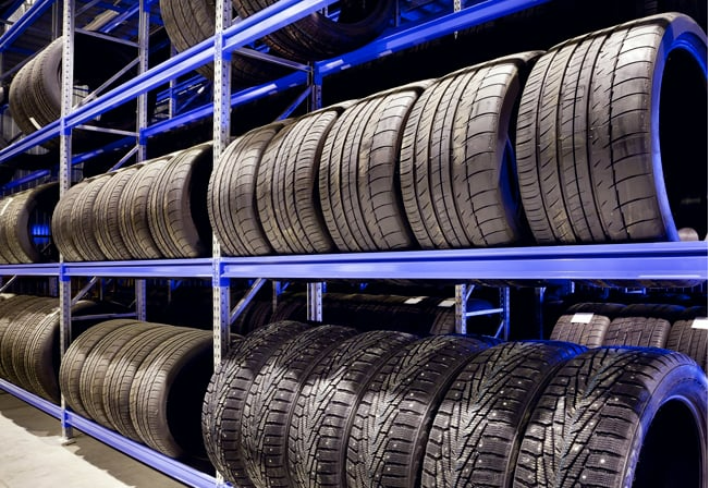 A warehouse filled with lots of tires on shelves.