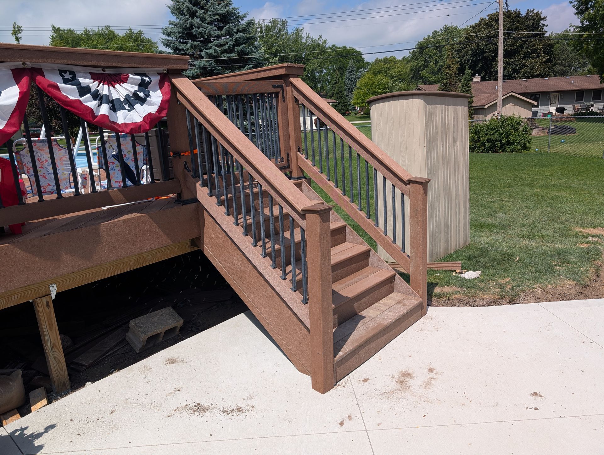 Decorated wooden porch stairs with red, white, and blue bunting on a house deck Decorated wooden porch stairs with red, white, and blue bunting on a house deck