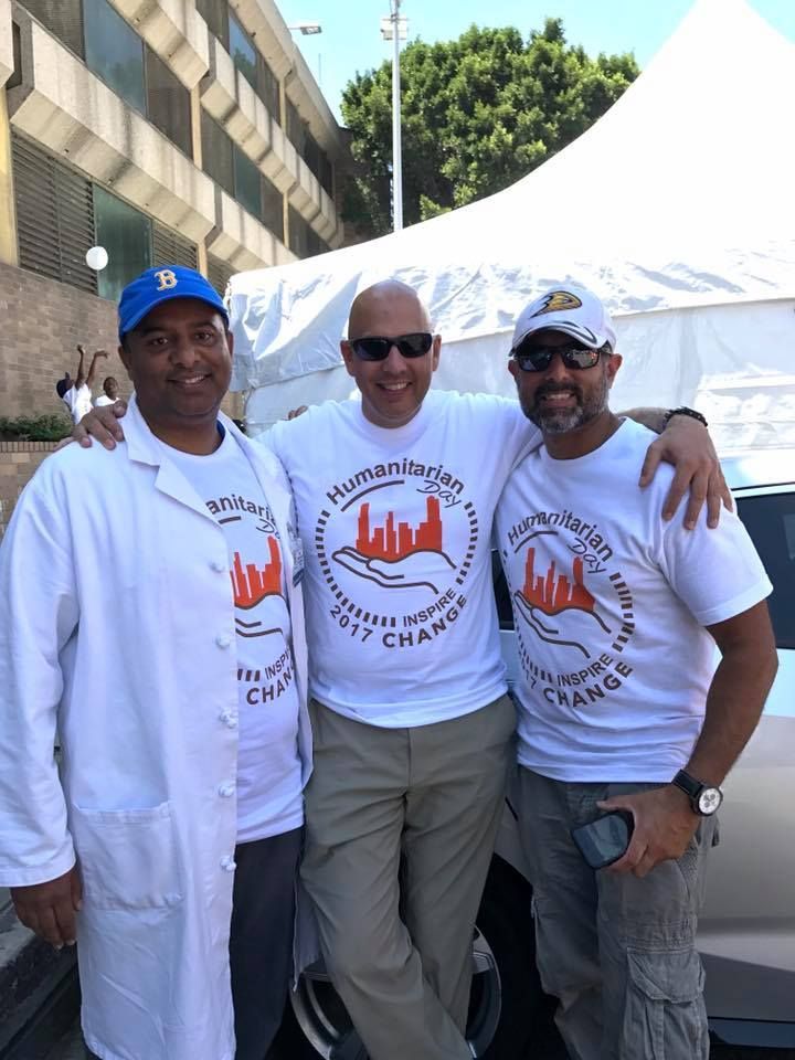 Three men in white shirts with the