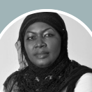 Woman wearing a black hijab looking directly at the camera.
