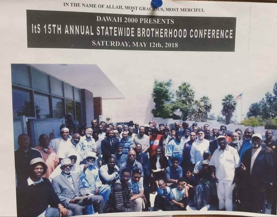 Group of people at a conference. Sign reads 