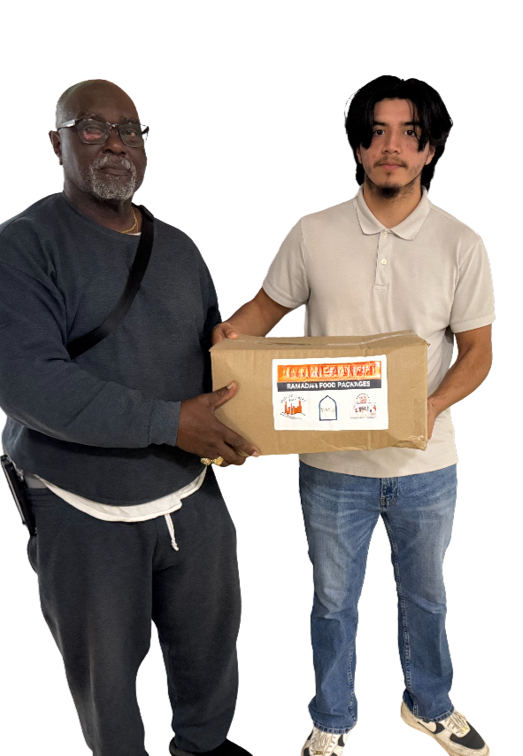 Two people holding a brown package with a sticker. One person is wearing a gray sweater, and the other is wearing a light-colored polo shirt.