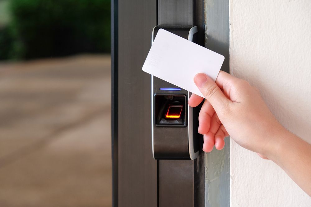 A Person is Using a Fingerprint Scanner to Open a Door — Cambush Security Solutions NT in Alice Springs, NT