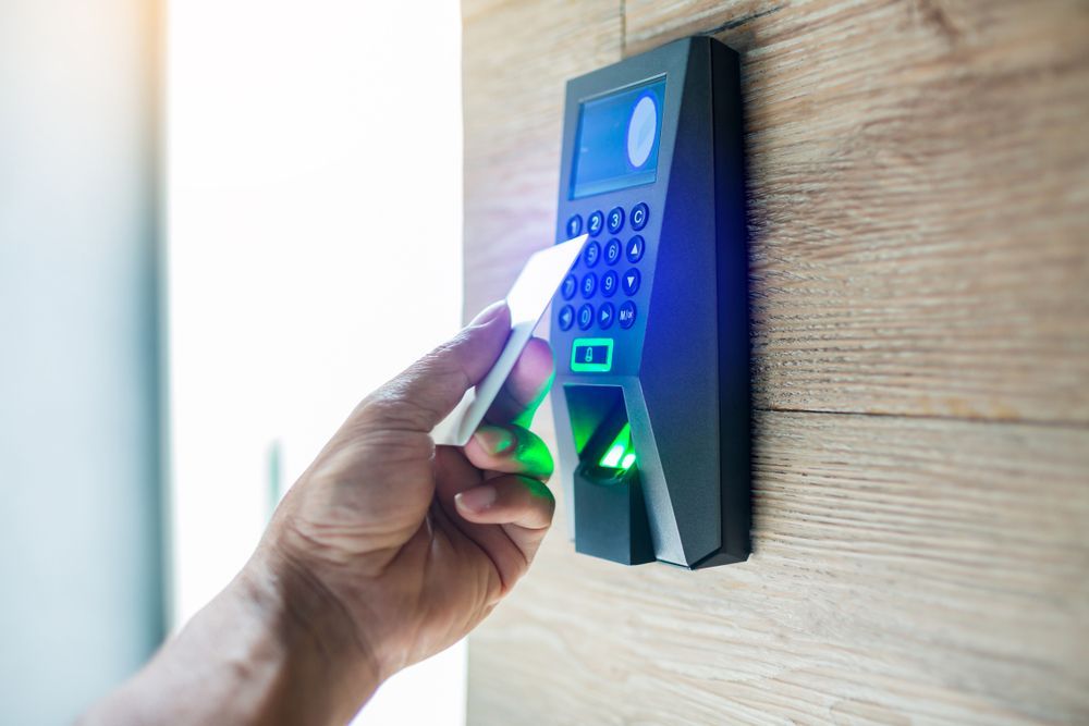 A Person is Using a Fingerprint Scanner to Access a Door — Cambush Security Solutions NT in Katherine, NT
