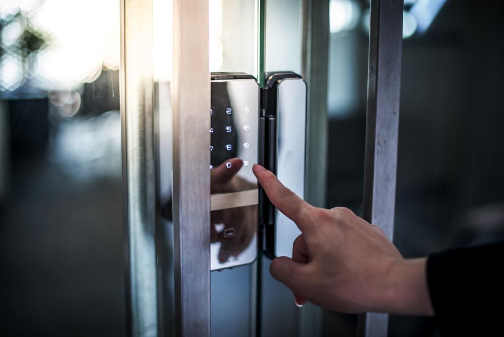 A Person Using the Door Intercom for Secure Access — Cambush Security Solutions NT in Coconut Grove, NT