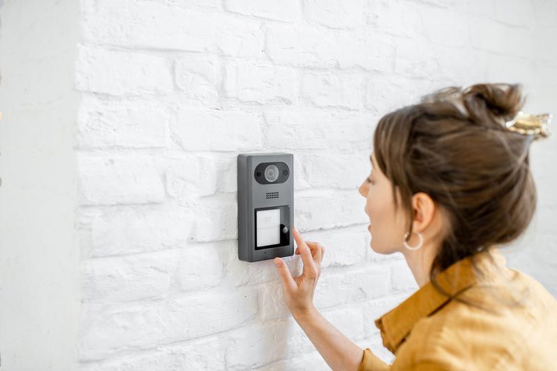 A Woman Utilizing an Intercom System for Enhanced Security — Cambush Security Solutions NT in Coconut Grove, NT